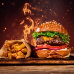 Tasty burger with french fries and fire.
